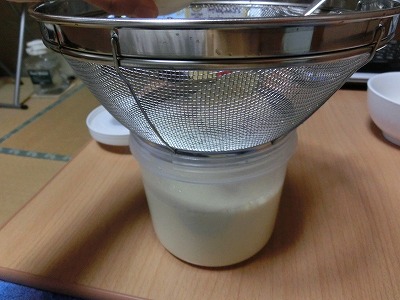 温めた豆乳にザルをセット