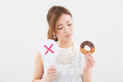糖質ダイエットをするドーナツを持つ女性