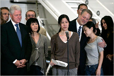 Laura Ling spoke to the news media as former Vice President Al Gore embraced Euna Lee after they arrived in Burbank, Calif., on Wednesday. Mr. Gore founded the company that employs the journalists.