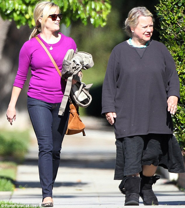 A family affair: Reese had her mother on hand to help out if the children at the party got too excitable