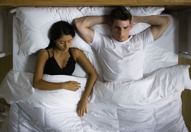 Multi-ethnic couple laying in bed