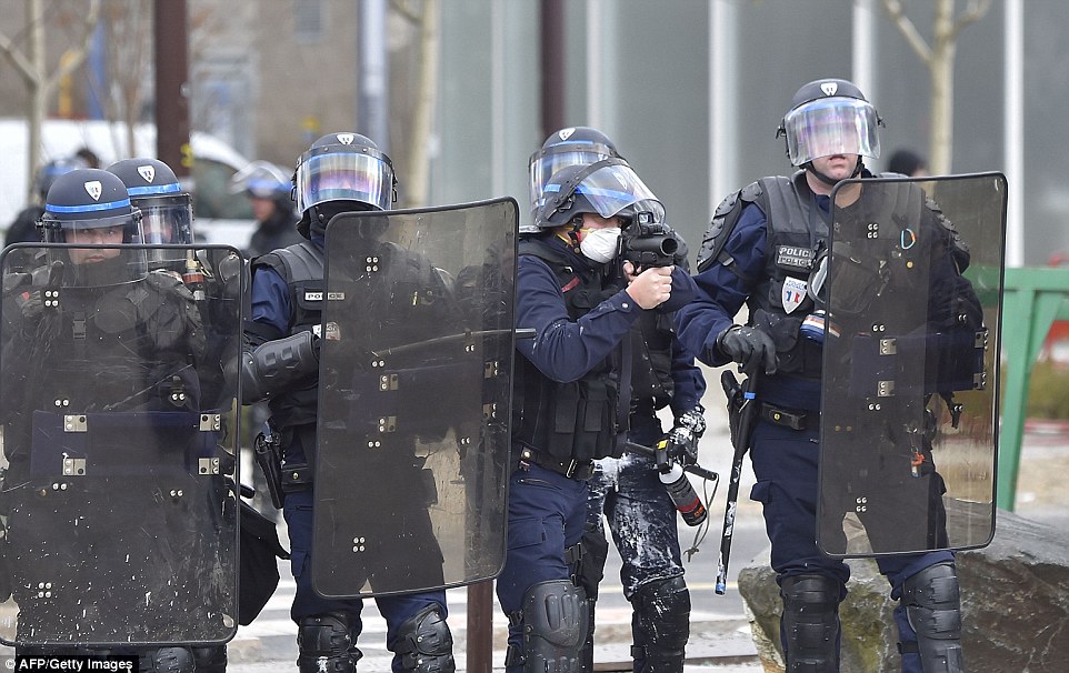 Protests against the reform kicked off on March 9, culminating in massive demonstrations on March 31 that brought 390,000 people on to the streets. Pictured: An anti-riot police office aims his teargas grenade gun  in Nantes