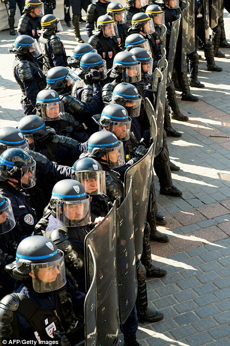 Riot police stand guard during a demonstration  in Lille